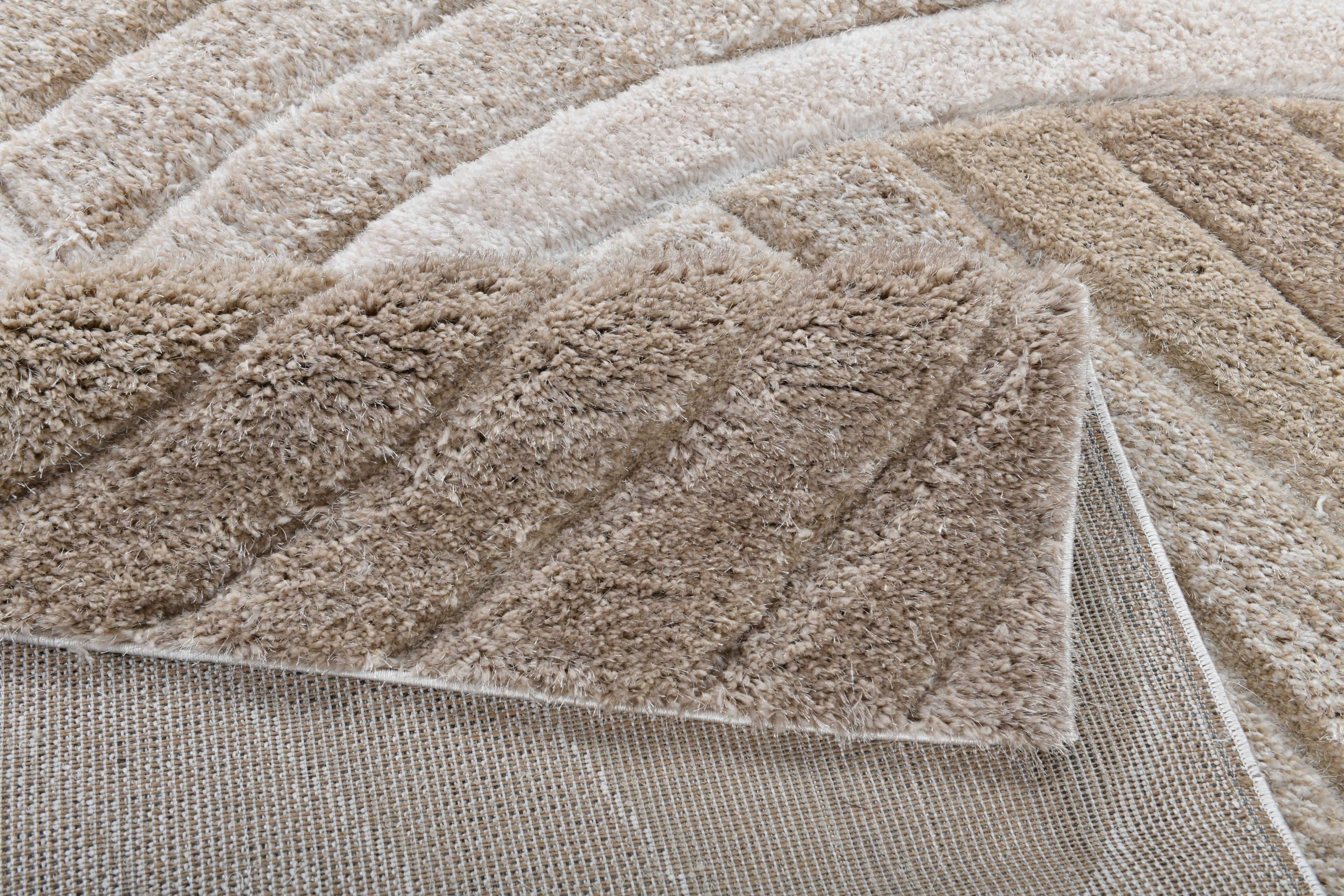 Backing detail of the Ucci beige shag rug showing thick plush pile and woven backing.