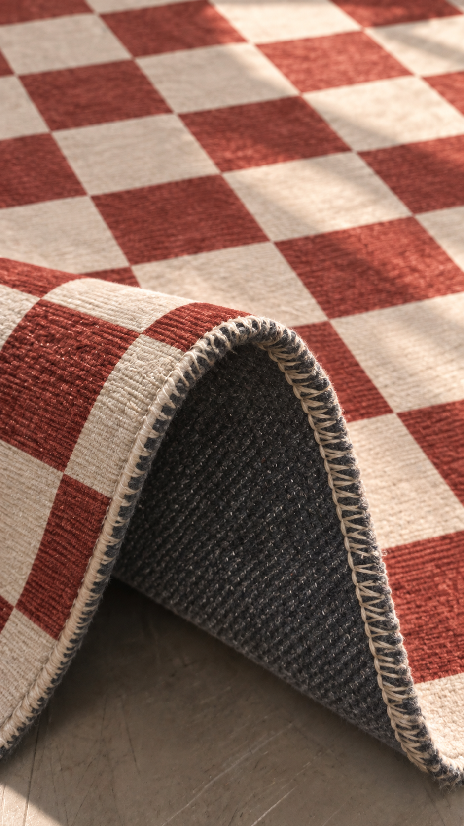 Apollo Sunday Check Area Rug — Red / Cream — folded rug detail in soft afternoon light. Digital visualization.
