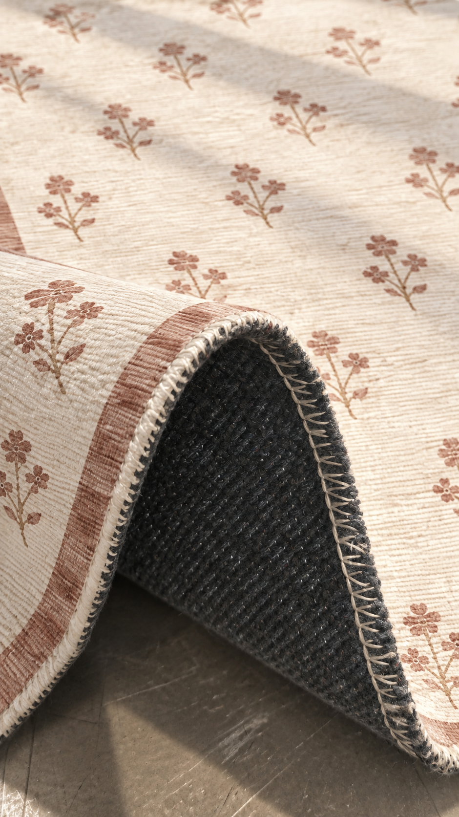 Apollo Posy Walk Area Rug — Dusty Rose / Cream — folded rug detail in soft afternoon light. Digital visualization.