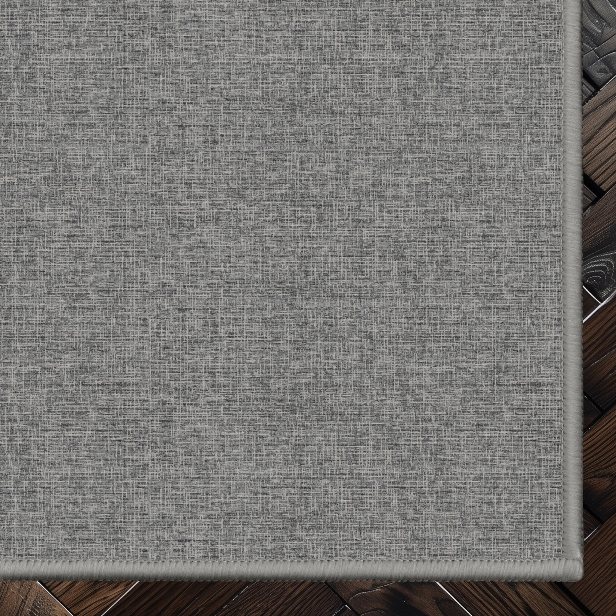 Wilfred Custom Rug - Monochrome Hatch , Low Pile, Easy Clean, Personalized Sizes - Well Woven - Grey rug corner on a dark wood floor
