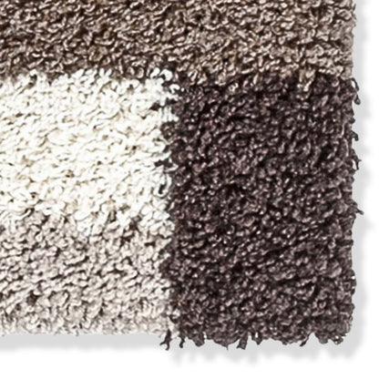 Close-up of a textured brown and beige shag rug