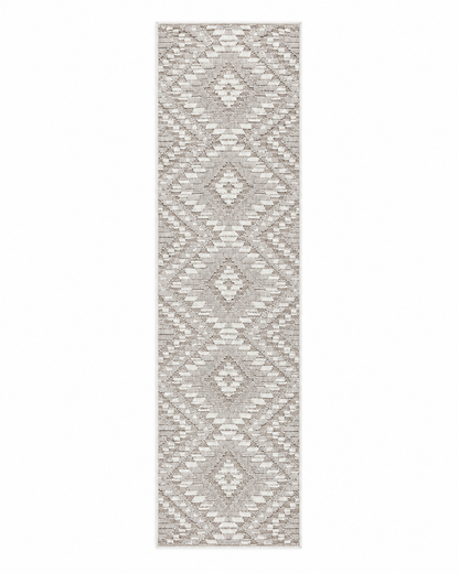 A long rectangular area rug with a geometric diamond pattern in light beige and off-white, shown flat against a white background.