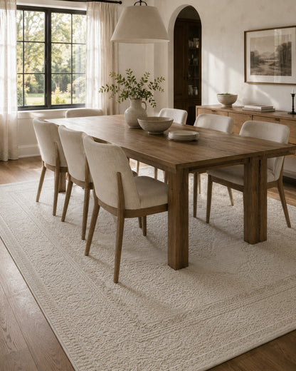 Lafayette Crest ivory and cream medallion area rug under a dining table