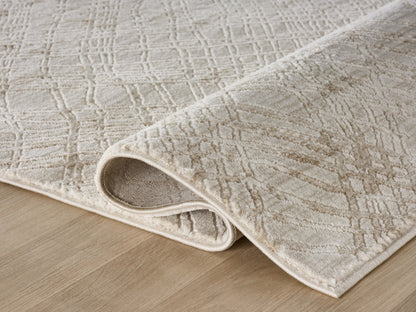 Lafayette Sterling cream and gold abstract area rug, rolled to show pile depth and the jute backing