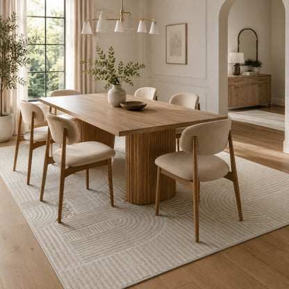 Lafayette Arc beige and cream curved lines area rug under a dining table