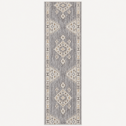 A long rectangular area rug with a distressed traditional pattern in gray, beige, and white, shown flat against a light gray background.
