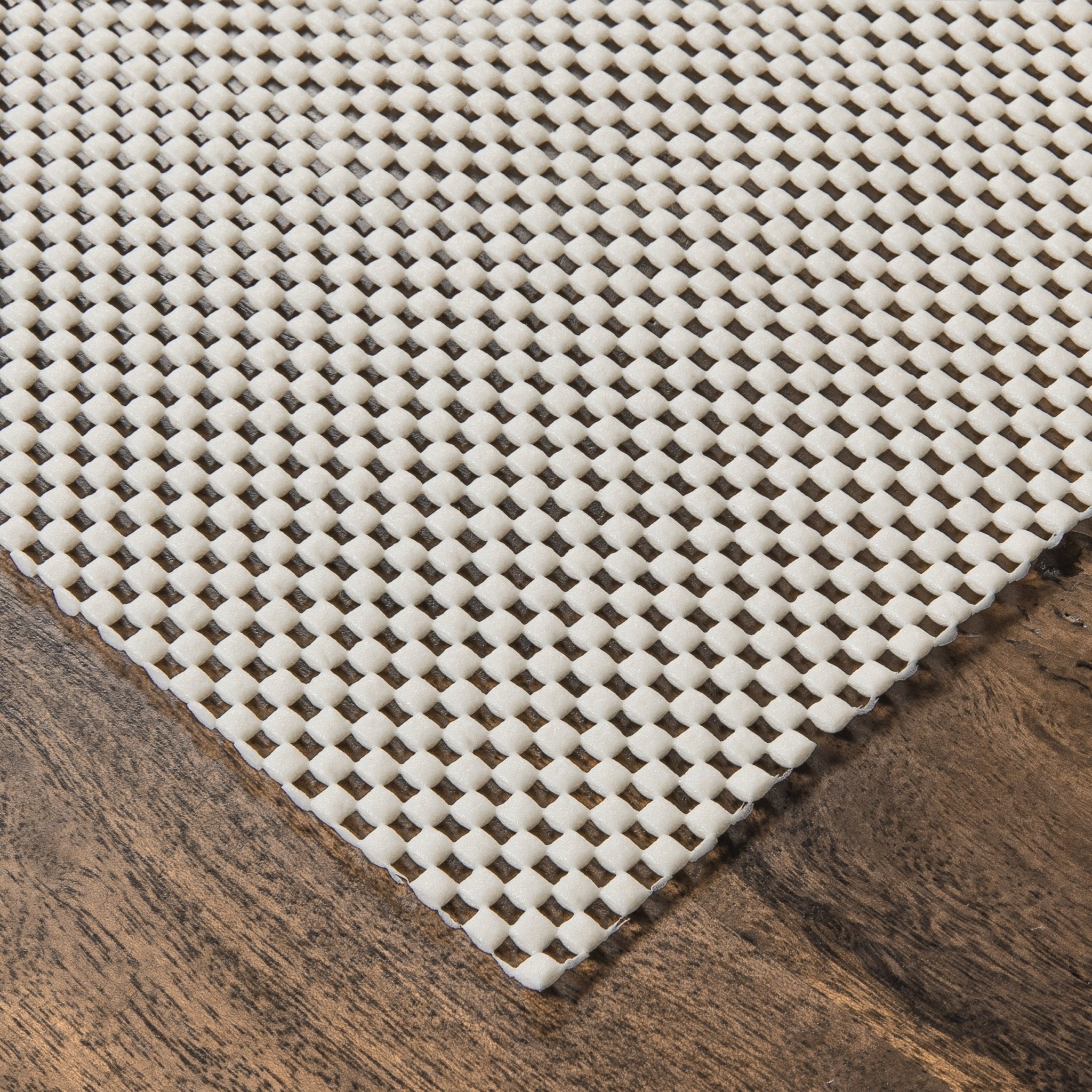 Elle Basics PVC Non-Slip Rug Pad - Close-up of a 1/8" thick rug pad on a wooden floor