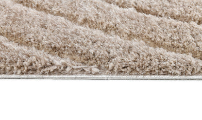 Side detail of the Ucci beige shag rug showing thick plush pile and bound edge