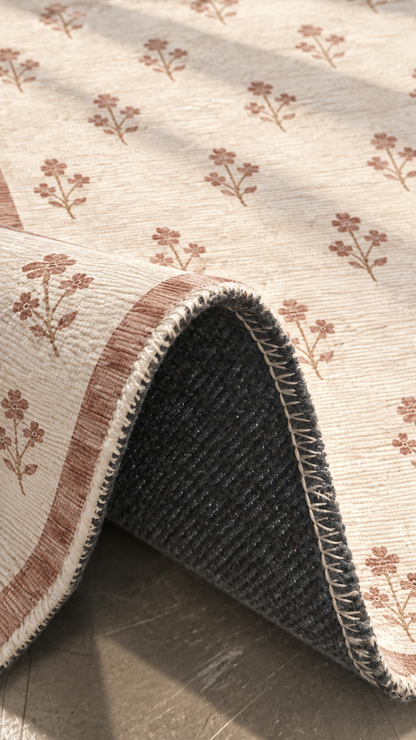 Apollo Posy Walk Area Rug — Dusty Rose / Cream — folded rug detail in soft afternoon light. Digital visualization.