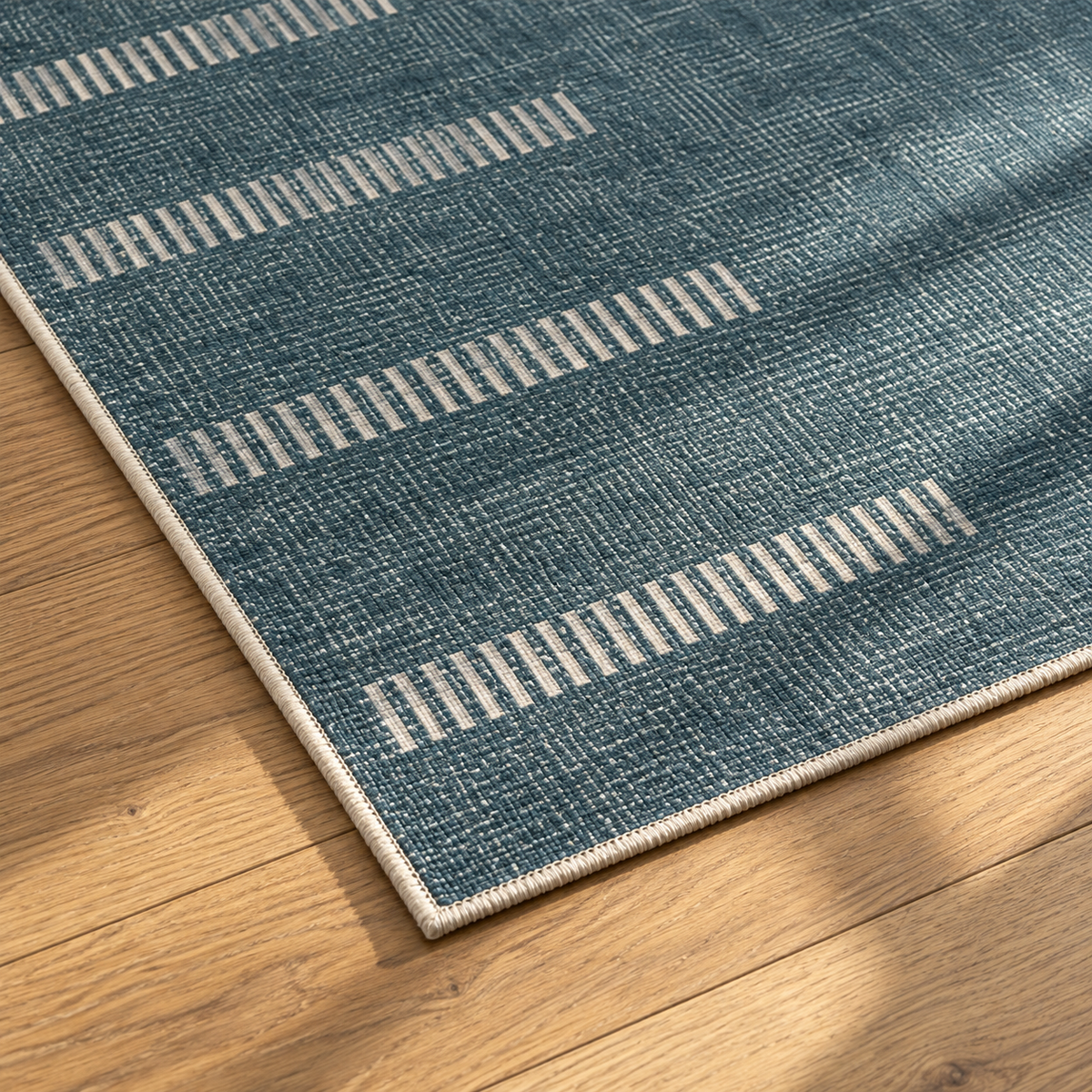 Apollo Interval Row Area Rug — Petrol Blue / Beige — corner and edge detail in soft afternoon light. Digital visualization.