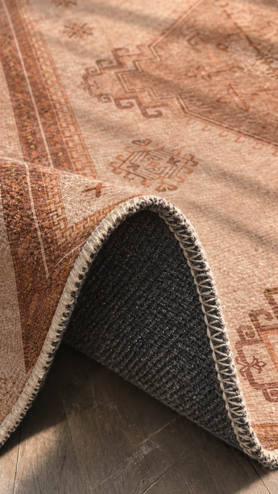 Apollo Wayfarer Court Area Rug — Terracotta / Beige — folded rug detail in soft afternoon light. Digital visualization.