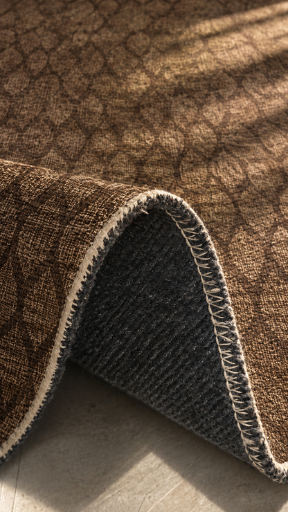 Apollo Brackenline Area Rug — Espresso / Beige — folded rug detail in soft afternoon light. Digital visualization.
