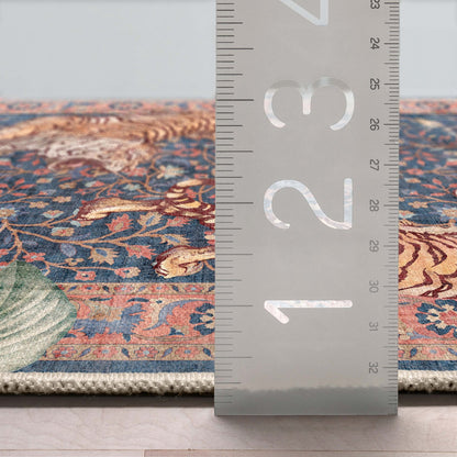 The washable tiger rug with a ruler showcasing its flat weave and low profile