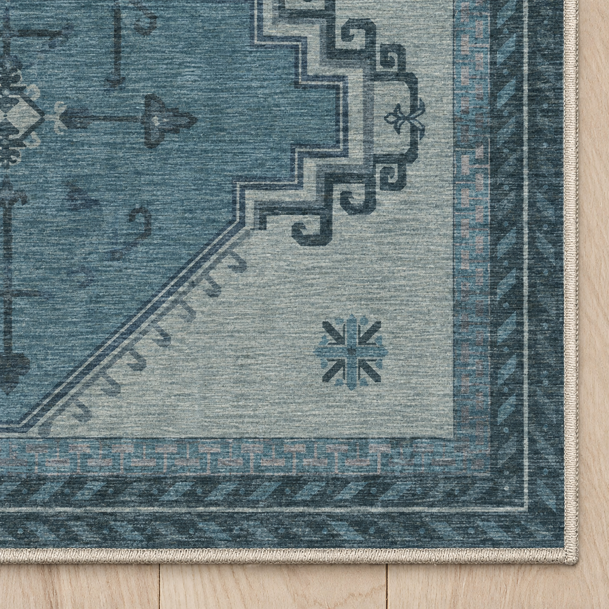 Top-down Apollo Wayfarer Court in Petrol Blue / Beige: chenille corner and cream serged edge — digital material visualization, not a finished-rug photograph.